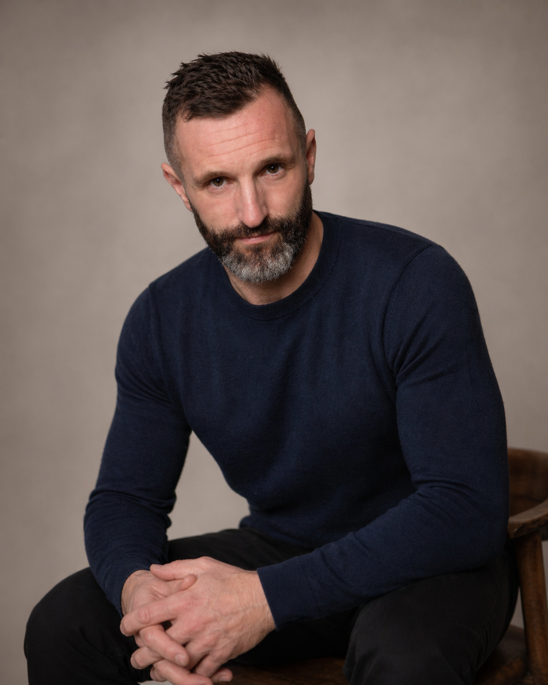 Wilson Meloncelli, seated portrait, navy sweater